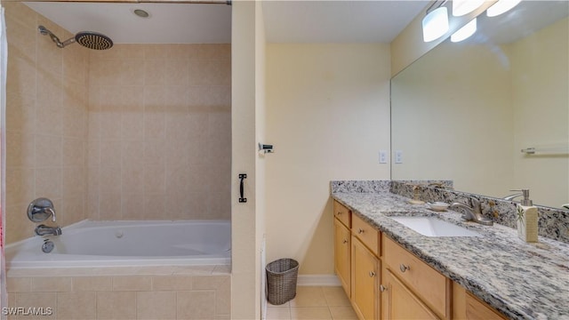 bathroom featuring vanity, tile patterned flooring, and tiled shower / bath