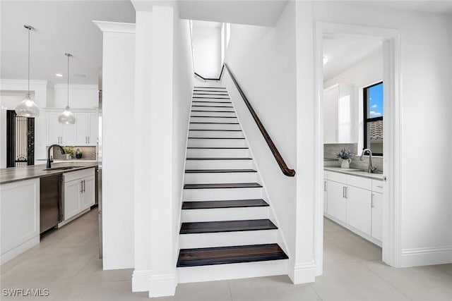 stairs with sink and tile patterned flooring