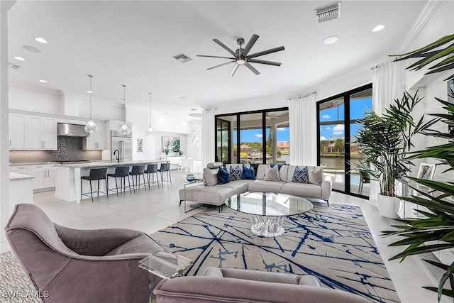 tiled living room featuring sink and ceiling fan