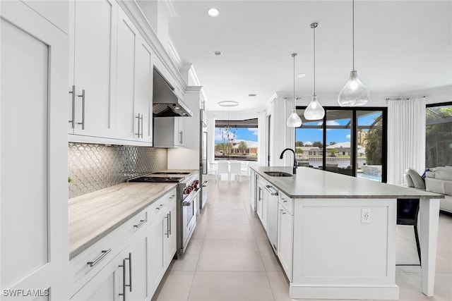 kitchen featuring white cabinetry, appliances with stainless steel finishes, and a kitchen island with sink