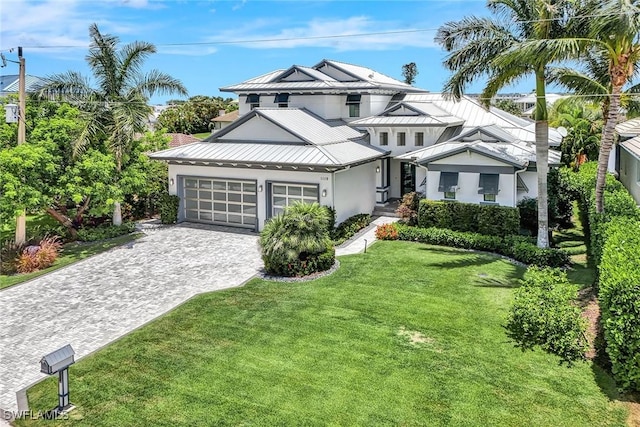 view of front of home with a garage and a front lawn