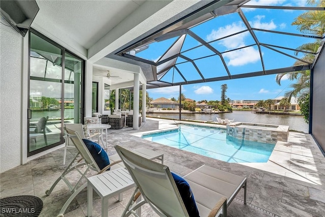 view of pool featuring glass enclosure, an in ground hot tub, a water view, and a patio