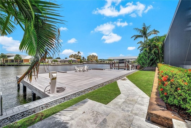 exterior space with glass enclosure and a water view