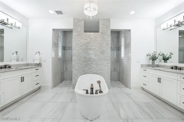 bathroom with vanity and shower with separate bathtub