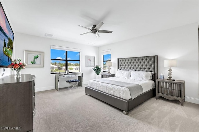 bedroom with ceiling fan and light carpet