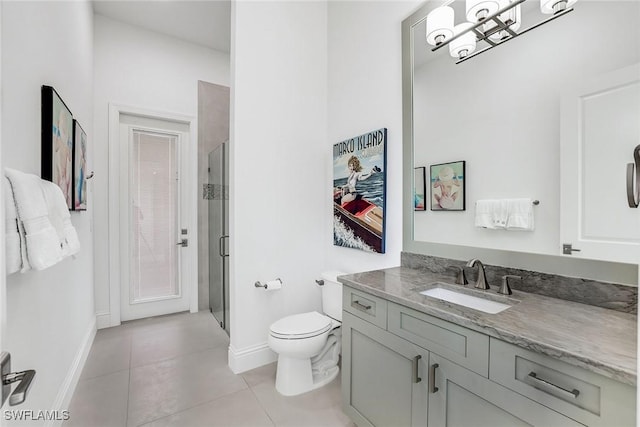 bathroom with vanity, toilet, tile patterned floors, and a shower with door