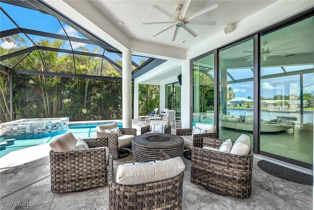 view of patio featuring ceiling fan, a water view, an outdoor living space with a fire pit, a lanai, and a pool with hot tub