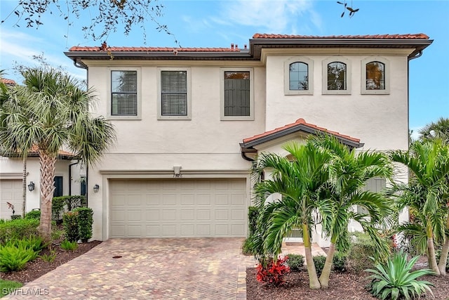 mediterranean / spanish-style house with a garage