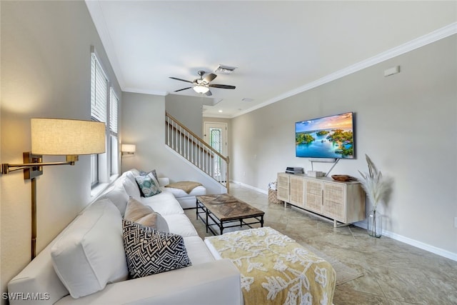 living room with ceiling fan, plenty of natural light, and ornamental molding