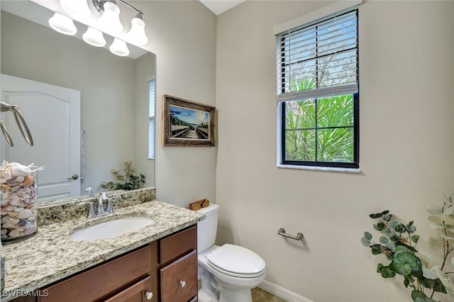 bathroom featuring toilet and vanity