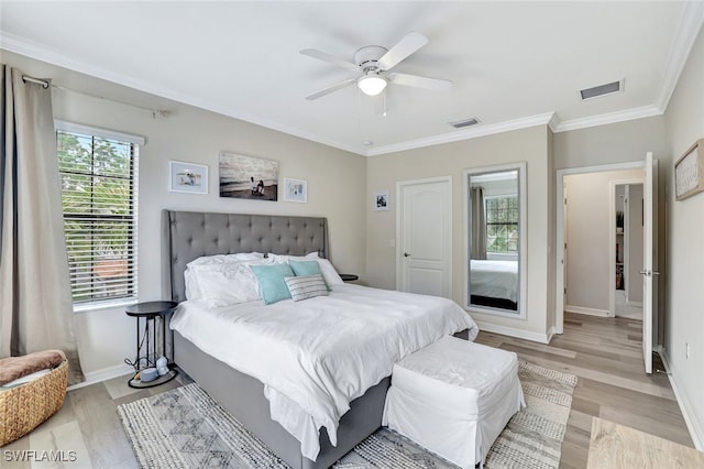 bedroom with ceiling fan, light hardwood / wood-style floors, and crown molding