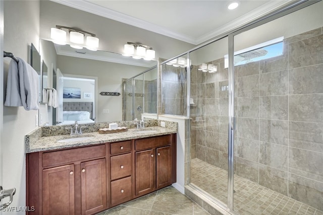 bathroom with vanity, a shower with shower door, ornamental molding, and tile patterned floors