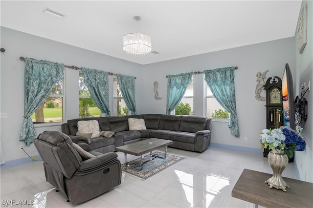 living room featuring light tile patterned floors and a chandelier