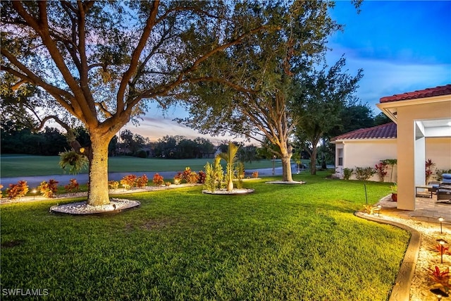 yard at dusk with a water view