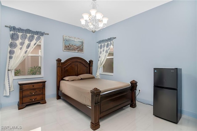 bedroom with multiple windows, black fridge, and a notable chandelier