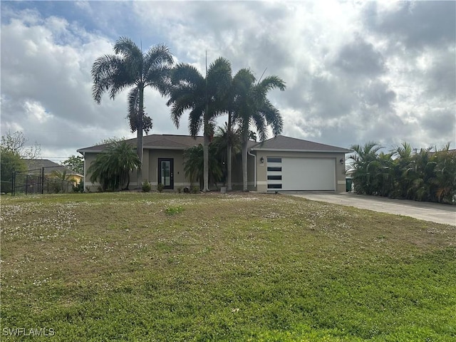 view of front of property with a garage, a front yard, and driveway