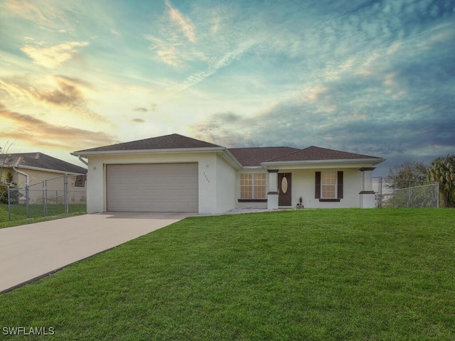 ranch-style home with a yard and a garage