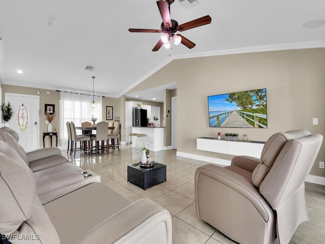 tiled living room with ceiling fan, lofted ceiling, and ornamental molding