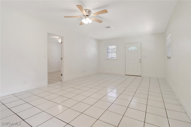 spare room featuring light tile patterned floors and ceiling fan