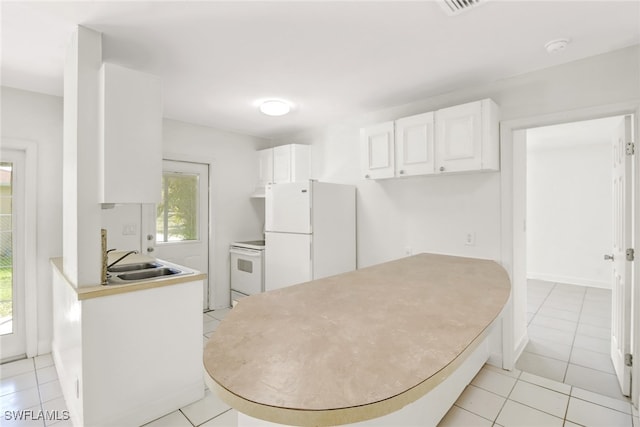 kitchen with white cabinetry, sink, light tile patterned floors, and white appliances