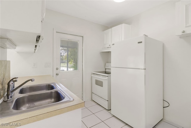 kitchen featuring white cabinetry, sink, light tile patterned floors, and white appliances