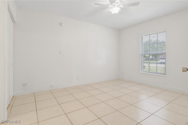 empty room featuring light tile patterned floors and ceiling fan