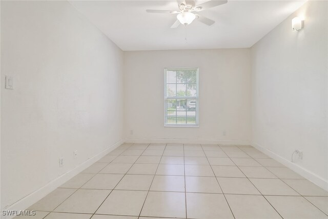 tiled empty room with ceiling fan