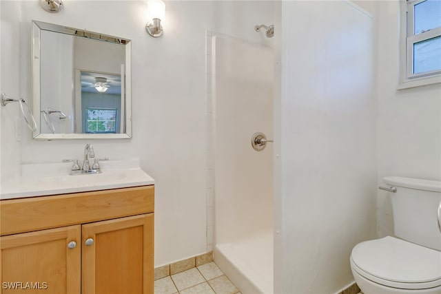 bathroom featuring walk in shower, vanity, toilet, and tile patterned flooring