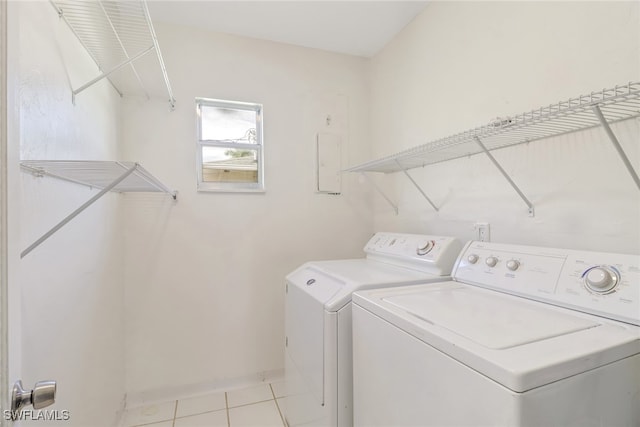 laundry room featuring separate washer and dryer and light tile patterned floors