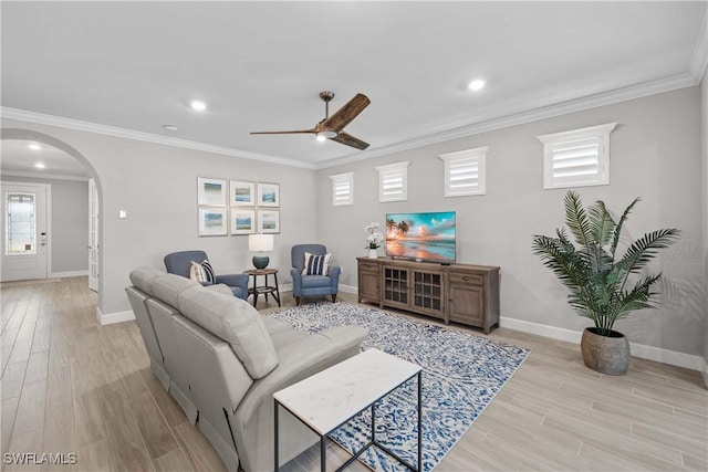 living room with crown molding, ceiling fan, and light hardwood / wood-style floors