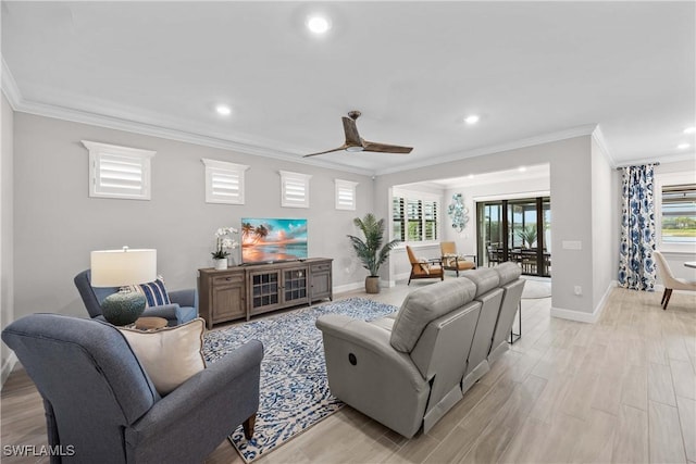 living room featuring ornamental molding, ceiling fan, and light wood-type flooring