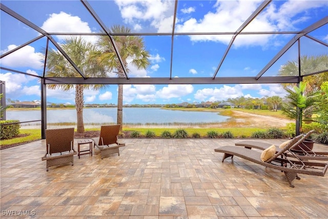 view of patio / terrace with a water view and glass enclosure