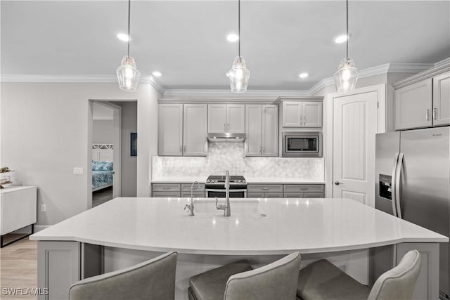 kitchen featuring pendant lighting, appliances with stainless steel finishes, and gray cabinetry