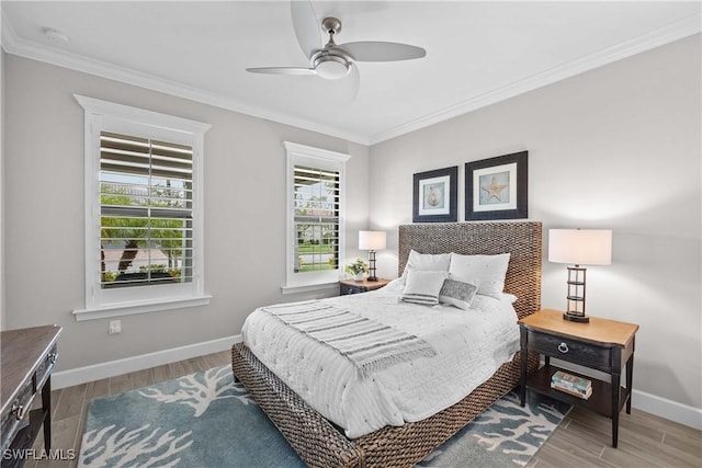 bedroom featuring crown molding, wood-type flooring, and ceiling fan