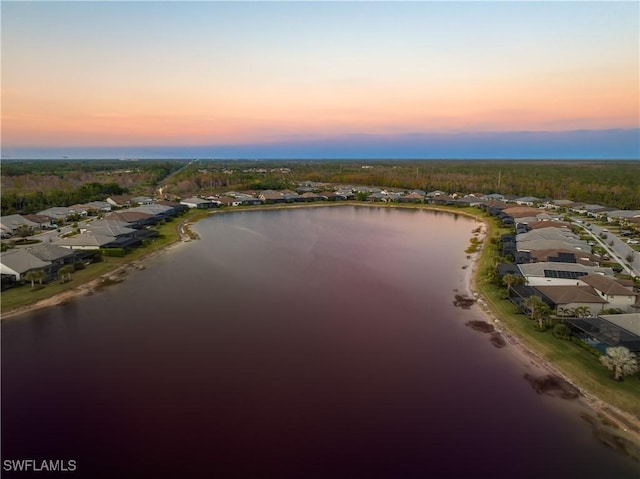 aerial view at dusk with a water view