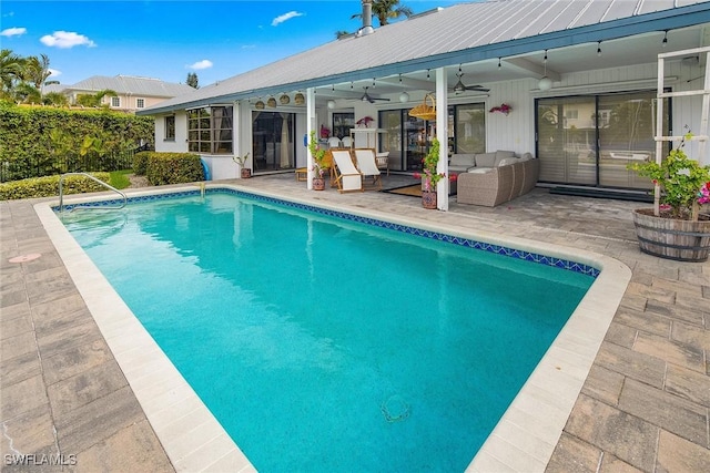 view of swimming pool featuring an outdoor living space, a patio area, and ceiling fan