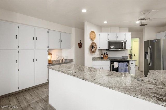 kitchen featuring light stone countertops, stainless steel appliances, white cabinets, and ceiling fan