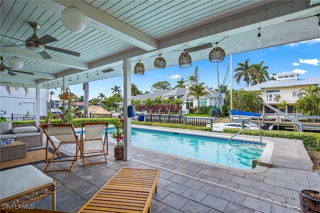 view of pool with an outdoor hangout area, ceiling fan, and a patio area