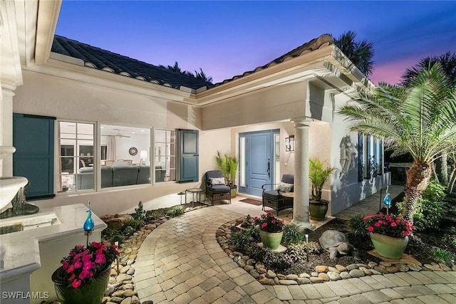 exterior entry at dusk with a patio