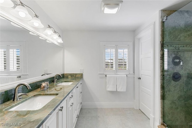 bathroom featuring vanity, plenty of natural light, and a shower with shower door