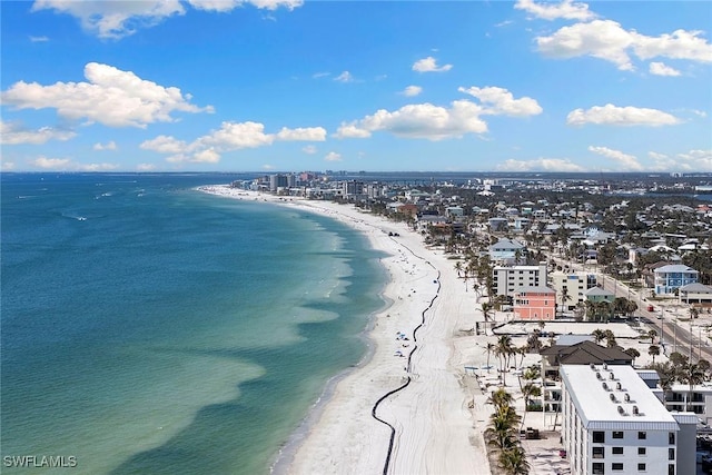 birds eye view of property with a water view and a beach view