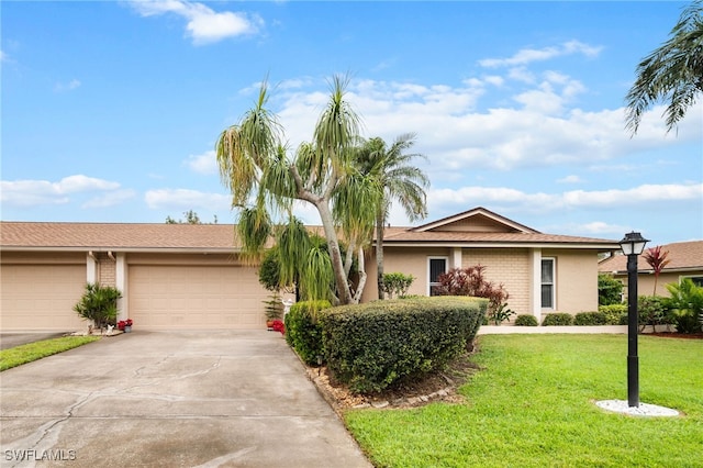 ranch-style home with a garage and a front yard