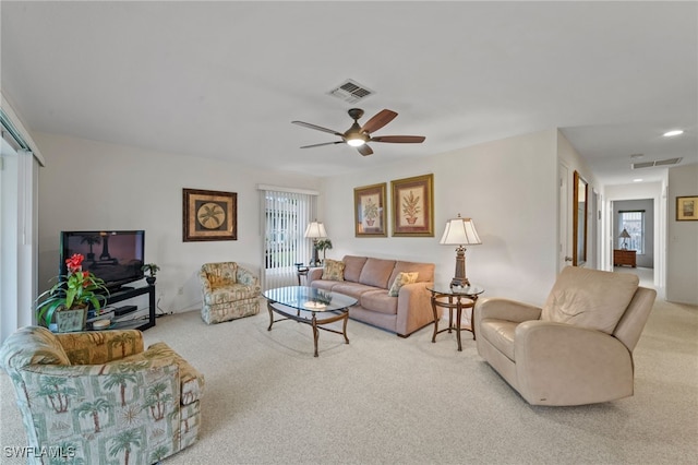 carpeted living room with ceiling fan