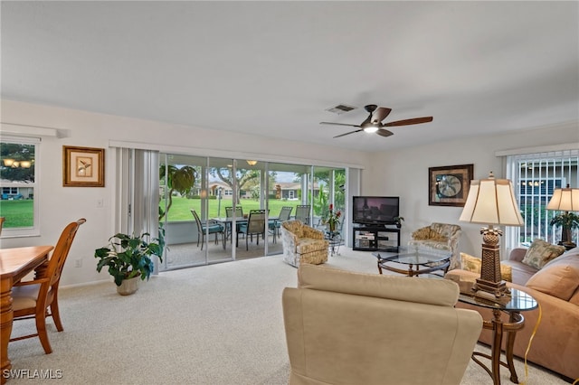 carpeted living room featuring ceiling fan