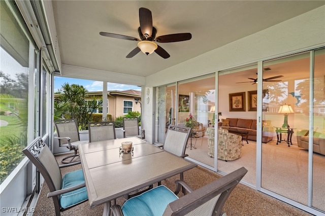 sunroom / solarium featuring ceiling fan