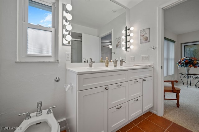 bathroom with a bidet, vanity, a shower with door, and tile patterned floors