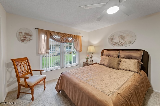 carpeted bedroom with a textured ceiling and ceiling fan