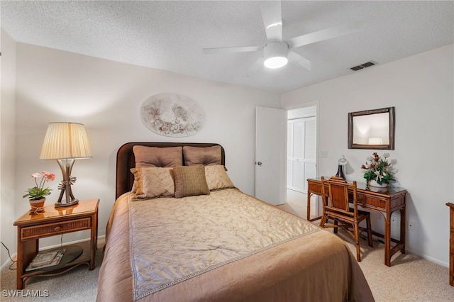 bedroom featuring a textured ceiling, a closet, ceiling fan, and carpet flooring