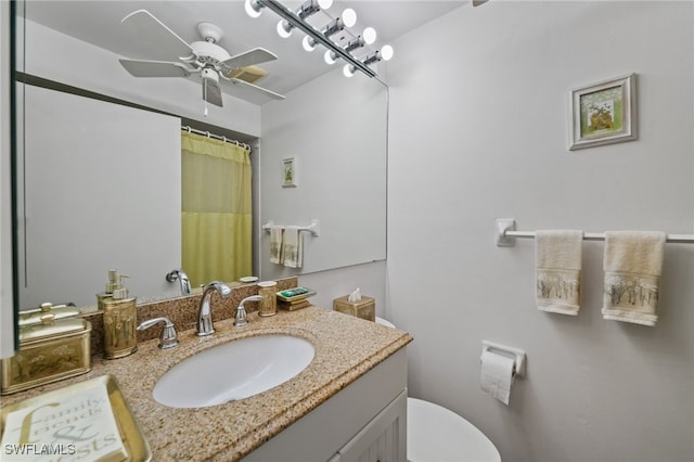 bathroom featuring ceiling fan, vanity, and toilet