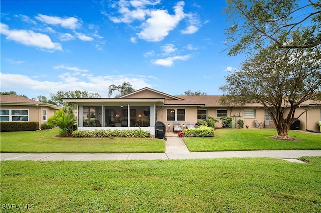 ranch-style house with a sunroom and a front yard